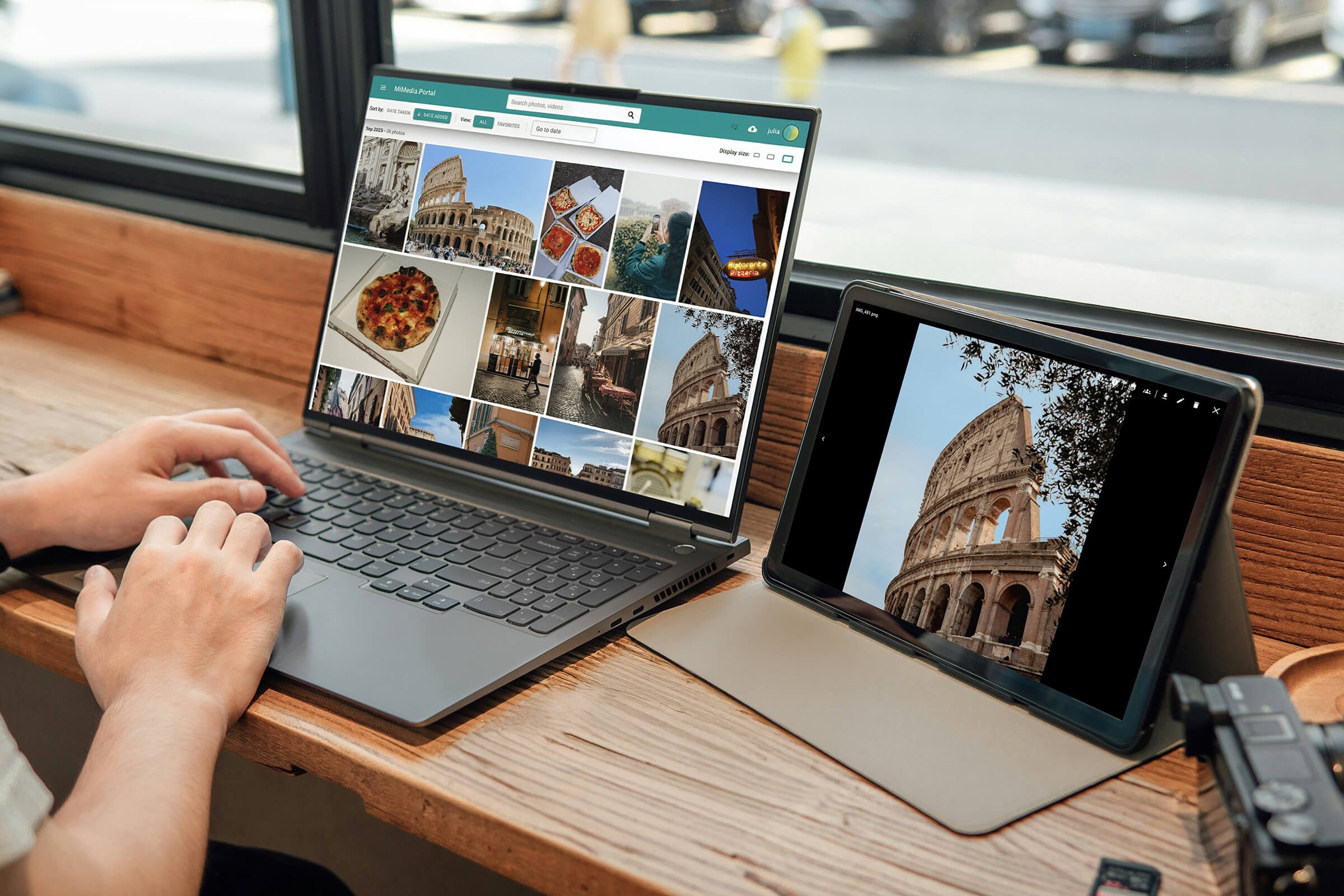 Person using a laptop and tablet to browse photos of the Colosseum and Italian food