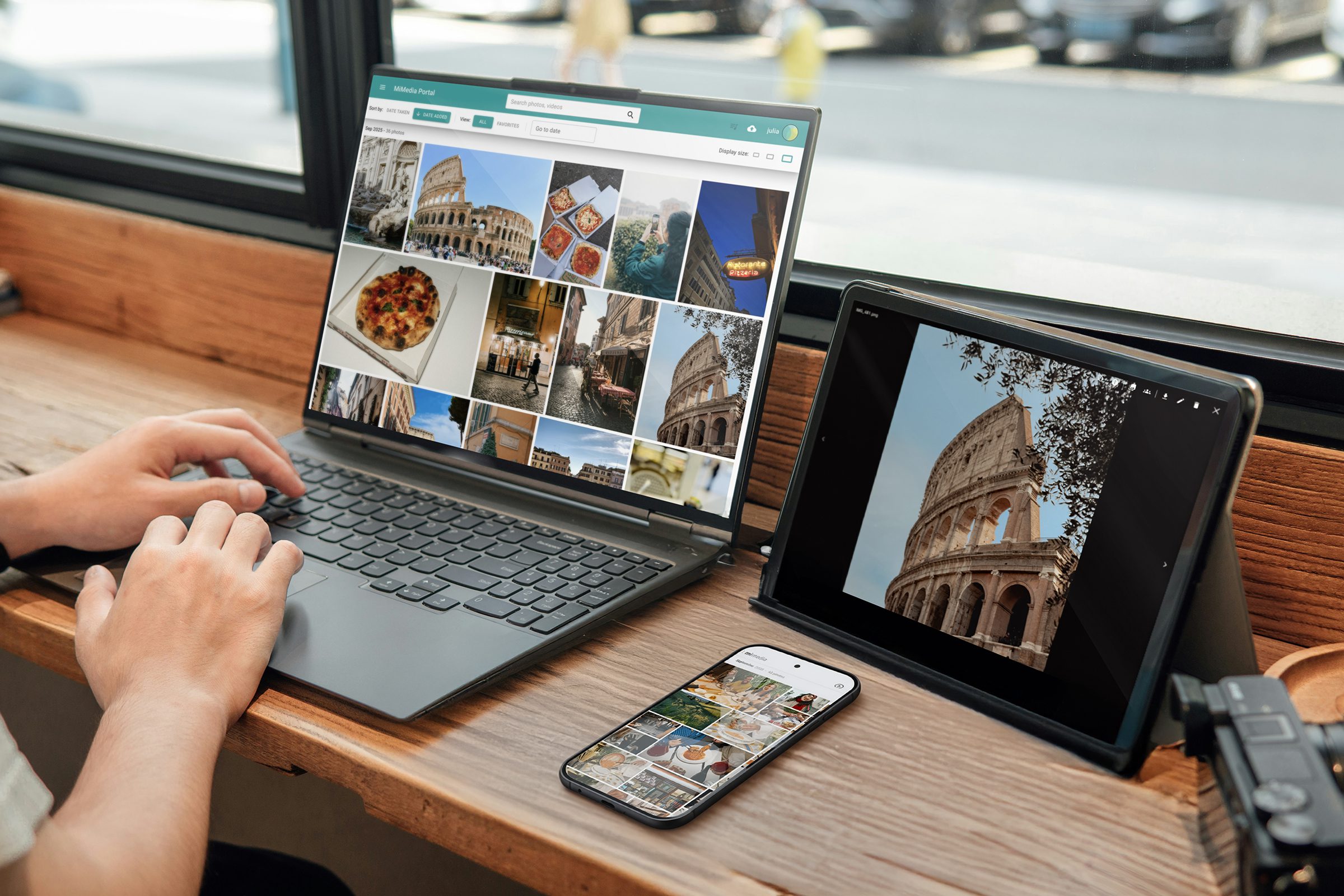 Person using a laptop, tablet, and smartphone to browse photos of the Roman Colosseum and Italian food on the MiMedia app